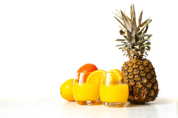 Wall Mural - glass of fresh pineapple and orange smoothie on wood table isolated b