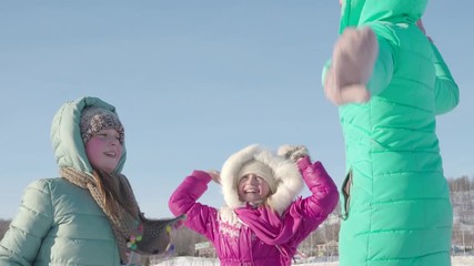 Wall Mural - Three children jump merrily on a winter day for a walk. Outdoor games in winter