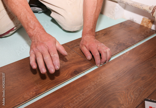 Worker Is Making Laminate Flooring In Apartment Maintenance