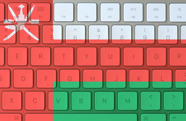 Oman flag and computer keyboard in the background