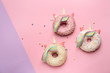 Cute unicorns made of sweet tasty donuts on color background