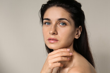 Portrait of beautiful young woman with natural makeup on light background