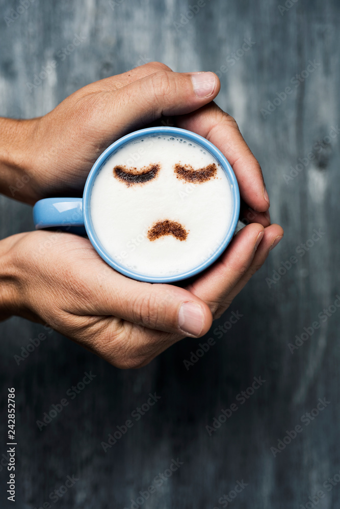 man with a cup of cappuccino with a sad face - obrazy, fototapety, plakaty 