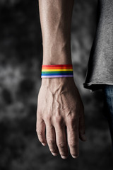 Poster - man with a rainbow-patterned ribbon in his wrist