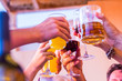 © simona - Clinking glasses above dinner table. Hands of people with glasses. Celebrating and toasting in honor of the wedding or other celebration - people having fun together drinking