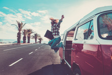 Happiness For Travel And Enjoying Wanderlust Concept For Beautiful Curly Crazy Woman Jumping Out The Old Van With Vintage Luggage - Joyful And Success Lifestyle For Alternative Hipster People