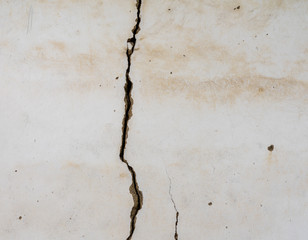 Large crack opening up on plastered wall of old building