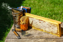 Beekeeper Working Tools On The Hive. Beekeeping Equipment On A Wooden Table Outdoors With Copy Space