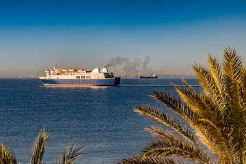Wall Mural - Ferry boat leaving Mediterranean port in the morning. 