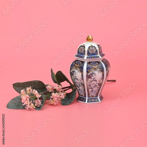 Fotografie, Obraz Classic oriental vase with jasmine branch isolated on pink (coral) background
