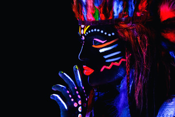 Woman with a neon makeup in ultraviolet light