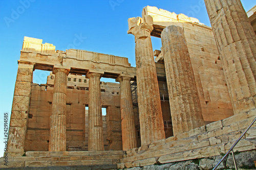 Fotografie, Obraz Columns near the entrance and Propylaea to the Acropolis just above the Theater Odeon of Herodes Atticus on the Acropolis in Athens, Greece