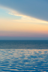 Wall Mural - infinity swimming pool with ocean background