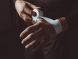 © Paul Schefz - Midsection of man wrapping hand with white boxing wrap