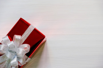 Christmas and Happy new year composition, Christmas  red present gift boxes with silver ribbon on wooden white background. Flat lay, top view, copy space.