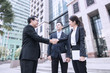 © khwanchai - business people negotiate and shake hands after successful agreement