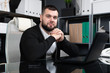 © Ivan Traimak - Portrait of young man sitting at table in office