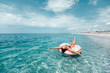© Alena Ozerova - Plus size woman on lilo relaxing on the beach