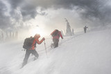 Fototapeta Na ścianę - climbers in mountain snowfall