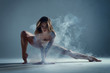 Dancing in cloud concept. Muscle brunette beauty female girl adult woman dancer athlete in fog smoke fume wearing dance bodysuit making sexy dance element performance on isolated grey background