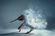 © Monstar Studio - Dancing in cloud concept. Muscle brunette beauty female girl adult woman dancer athlete in fog smoke fume wearing dance bodysuit making emotional dance element performance on isolated grey background