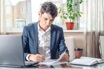 Businessman sitting at the table signing documents in the office. Registration and transactions with securities