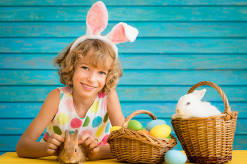 Wall Mural - Child playing with Easter bunny