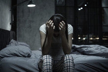 Young Woman Covering Face With Hands, Staying Up At Night, Feeling Helpless And Crying