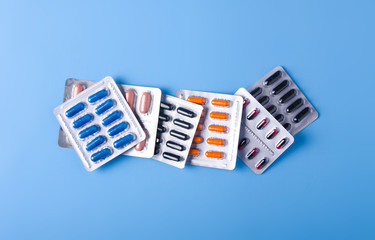 Sticker - Blister pills capsule on blue background, top view, medical pharmacy concept