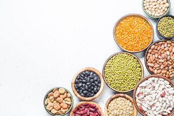 Wall Mural - Legumes, lentils, chikpea and beans assortment on white.