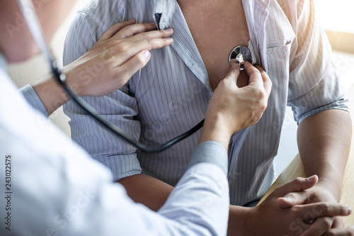 Cuadros en Lienzo Doctor using a stethoscope checking patient with examining, presenting results s