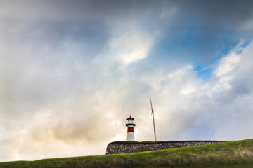 Poster - Lighthouse in Torshavn, the capital of Faroe Islands during sunset in summer with clouds in the sky. 