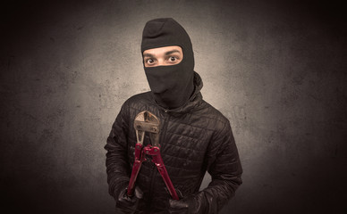 Wall Mural - Burglar standing in black clothes and balaclava on his head.