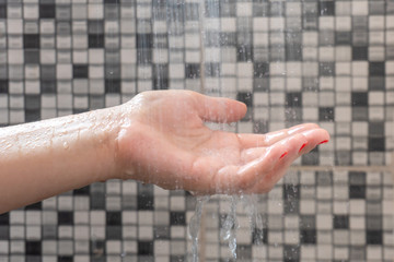 Wall Mural - Soft selective focus of hands and droplets of water from shower