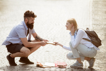 Sexual attraction. Couple in love on summer street. Hipster helping and looking at sexy girl. Bearded man and sexy woman falling in love. Love at first sight. Romantic date and dating