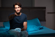 © Elnur - Man watching tv at night in bed