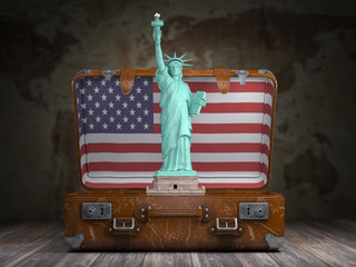 Statue of liberty and vintage suitcase with flag of USA. Travel and tourism  to NY New York city and USA concept.