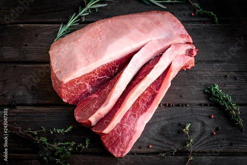 Cuadros en Lienzo sliced raw piece of marble beef brisket on wooden background, top view