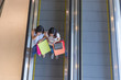 © Quang - Top view of young shopping girls using smartphone on the escalator