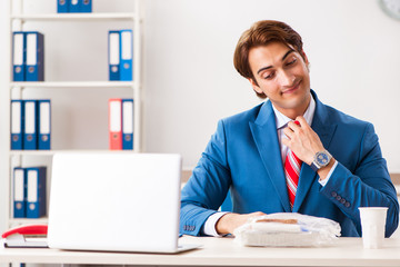 Wall Mural - Man having meal at work during break