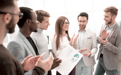 Wall Mural - close up.business team applauding while standing in the office