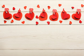 Wall Mural - Valentine day background, paper hearts border on wood, copy space