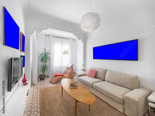Fotografía Poster template in a cozy stylish bright living room with natural ratan carpet, sofa, wooden table, plants and gallery on wall