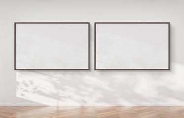 Two horizontal frames hanging on a wall mockup 3d rendering