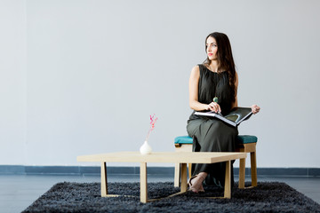 Young woman in the room with a book