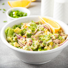 Canvas Print - Salad with tuna, avocado, onion, egg and lemon. Spring healthy delicious lunch on light background