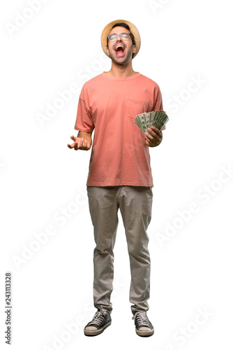 Fotografía Man holding many bills shouting to the front with mouth wide open on isolated wh