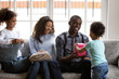 © fizkes - Cute little boy son gives present in gift box to happy african dad celebrating daddys birthday, black family congratulating excited father with his day make pleasant surprise, family celebration