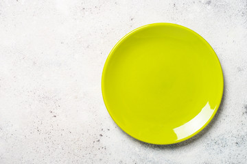 Wall Mural - Green plate on light stone table.