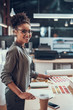 © Yakobchuk Olena - Charming afro american lady working on new project at modern office